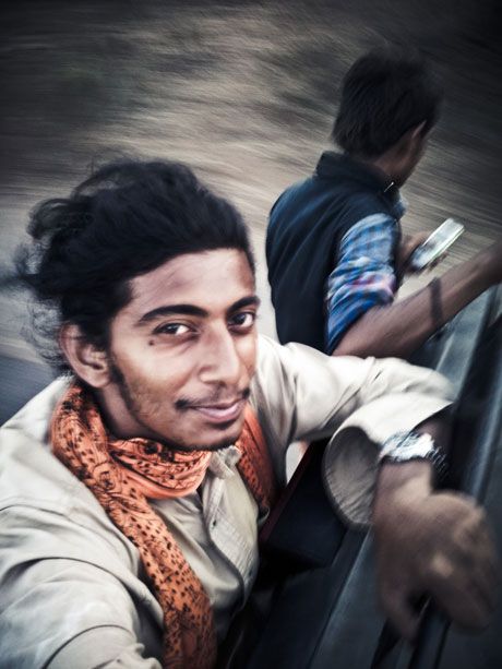 Selfie At Warp Speed. Hanging on the back of a rickshaw somewhere near Sasan in Gujarat.